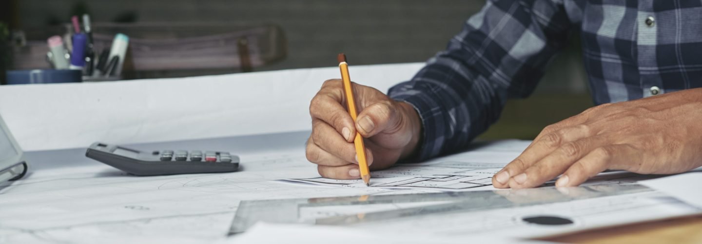 Close-up image of architect sketching construction project